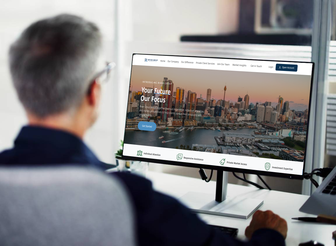 A man sitting in front of a computer monitor.